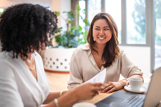 istock Japanese and Hispanic Businesswomen Collaborating in Office 2247209670