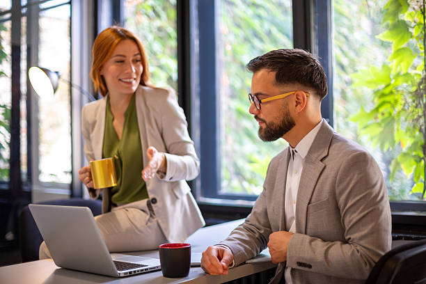 istock Business colleagues collaborating in modern office discussing project 2247210230