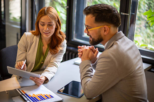 istock Business professionals discussing data charts on a digital tablet 2247211224