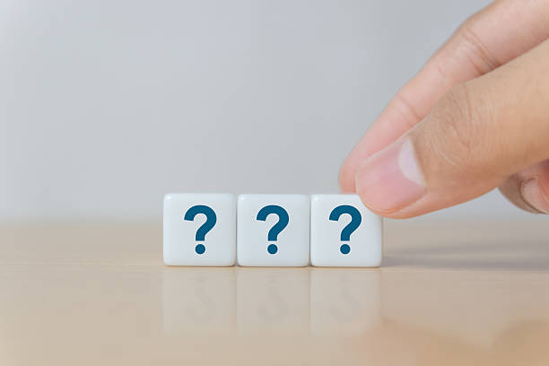 istock Dice with sign question mark symbol on wood table 2247213735
