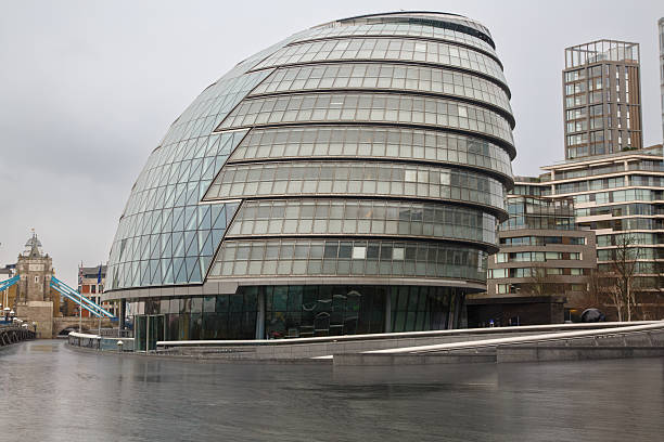 The Modern architecture City Hall building at the Thames river waterfront, Southwark, London, England
