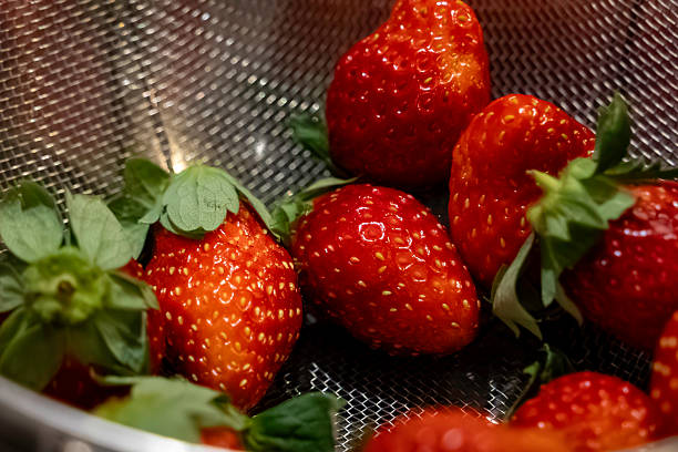 metallic strainer filled with fresh,Red strawberries