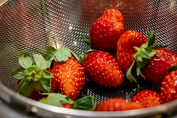 metallic strainer filled with fresh,Red strawberries