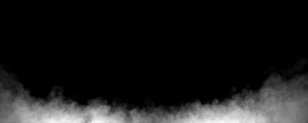 istock Realistic white smoke rising on a dark black background, creating a misty atmospheric effect perfect for design overlays, dramatic scenes, visual effects, and abstract creative compositions. 2247224818