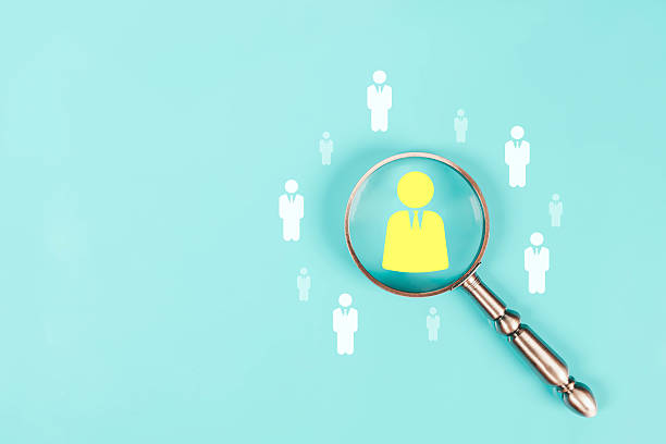 istock A magnifying glass focusing on a highlighted human icon, symbolizing recruitment, candidate search, HR analytics, talent identification, modern employee selection in clean, minimal business concept. 2247226245