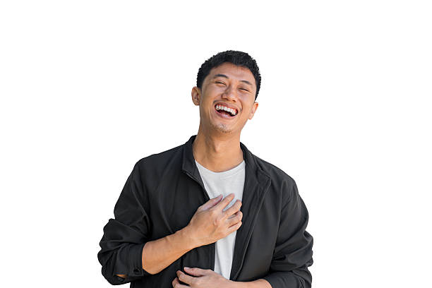 istock Young Asian man in black coat laughing happily on white background. Happiness concept. Positive energy. Good mood person. Funny. Thai man. 2247227259