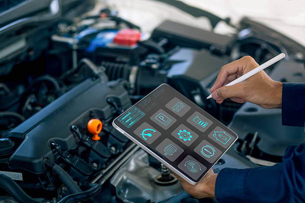 istock A mechanic uses a digital tablet to diagnose engine performance, monitor system data, and perform smart car maintenance. Ideal for automotive technology, vehicle diagnostics, and modern repair services. 2247229156