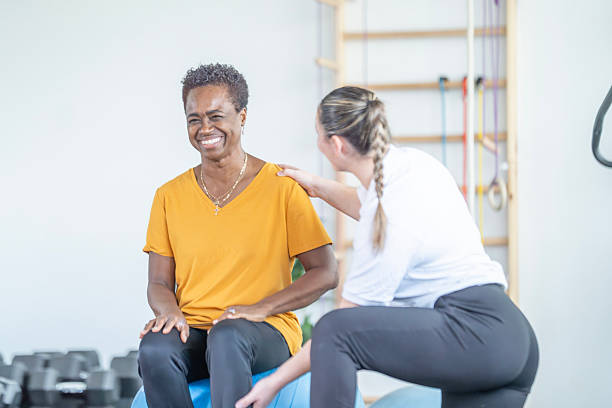 istock Affectionate Gym Session: African American Woman Smiles While Receiving Support From Trainer During Personal Fitness Meeting 2247229192