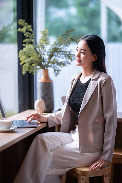 istock asian freelance people business female talking making using casual working with laptop computer for browsing internet, chatting and blogging and smartphone,notebook in coffee shop. 2247231660