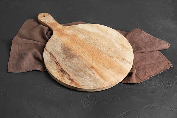 istock Wooden cutting board and napkin on black table 2247233323