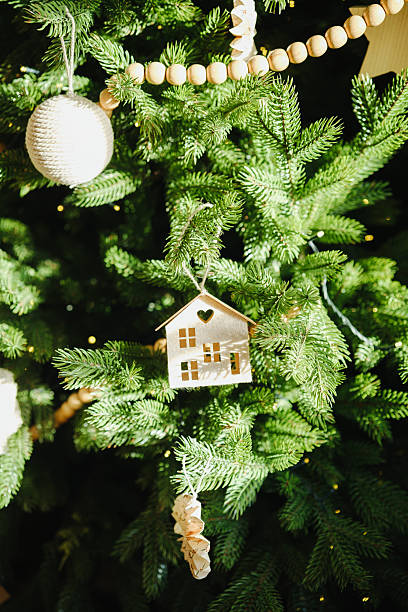 istock Green fir tree branches with simple holiday ornaments and warm lights, festive 2247233843
