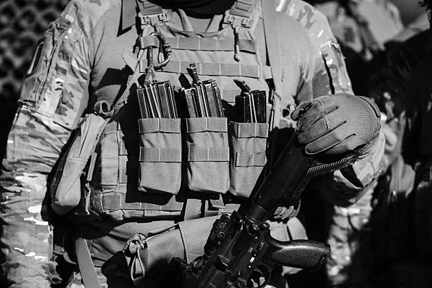 Re-enactors Dressed As World War II Russian Soviet Red Army Soldiers Marching Through Forest. Photo In Black And White Colors. Soldier Of WWII WW2 Times.
