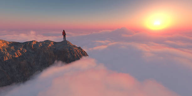 istock Hiker standing on rocky peak above clouds during vibrant sunrise 2247234278