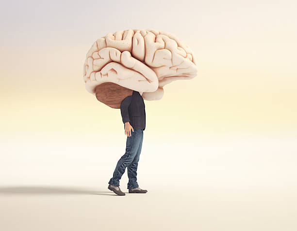 istock Person walking with a large brain as a head in a surreal setting at sunset 2247234286