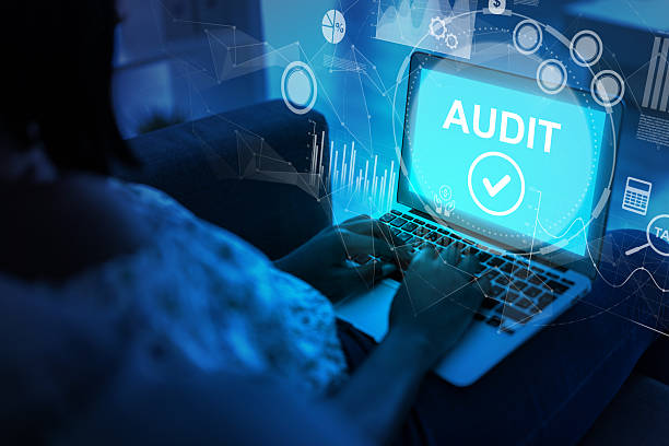 istock Person conducting a digital audit on a laptop in a darkened environment at night 2247236483
