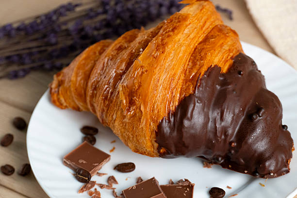 istock Chocolate-dipped croissant with coffee beans and lavender 2247236768