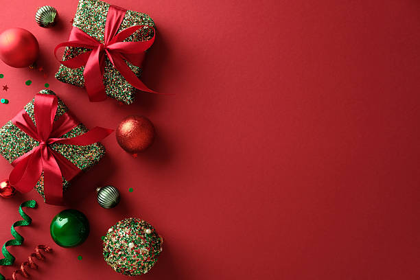 istock Luxury red Christmas background with sparkling gift boxes, red and green ornaments. Flat lay, top view. 2247236774
