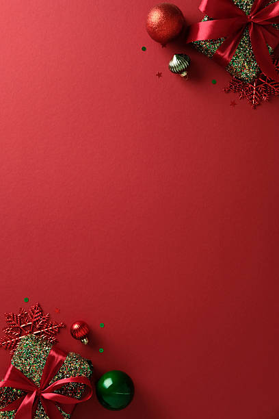 istock Minimalist Christmas vertical background featuring single gift boxes and ornaments in opposite corners. 2247236781