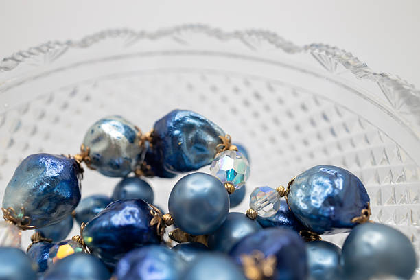 istock Antique  footed crystal bowl with blue jewelry beads 2247237072