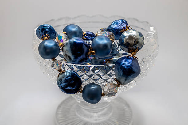 istock Antique  footed crystal bowl with blue jewelry beads 2247237090