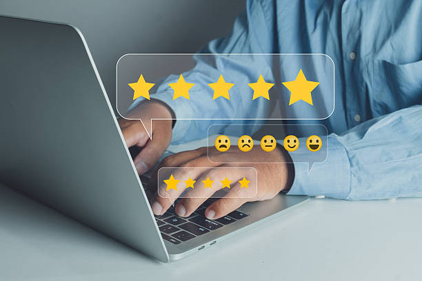 istock Businessman using a laptop to provide a five-star rating and positive emoticon feedback, symbolizing customer satisfaction and excellent service. 2247237338