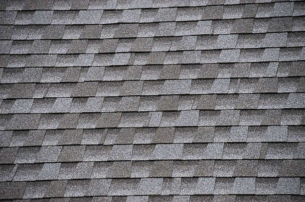 istock close up on new installed roof shingle 2247239102