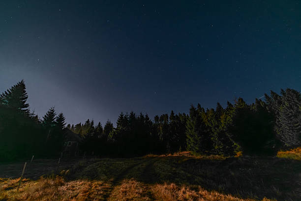 Autumn full moon night with clear starry sky in Krusne mountains