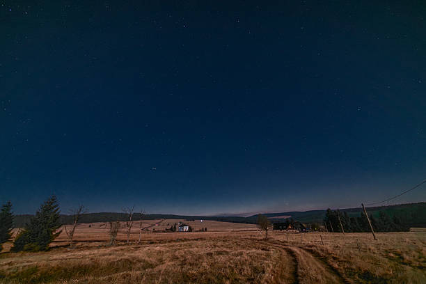 Autumn full moon night with clear starry sky in Krusne mountains