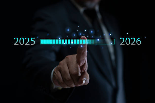 istock Businessman's hand interacting with a digital loading bar transitioning from 2025 to 2026. Concept of progress, future planning, time, and future planning in business and technology. 2247239973