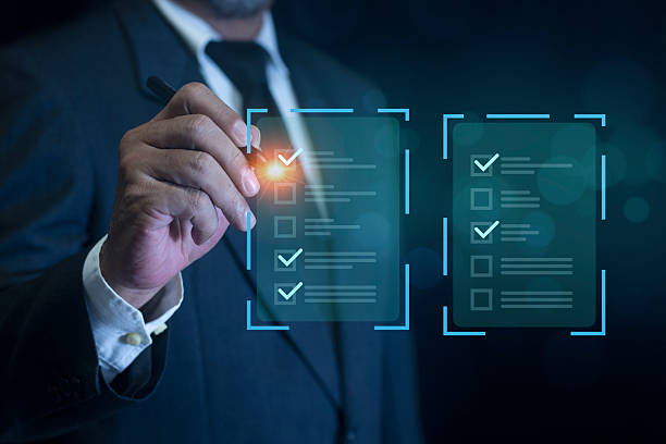 istock Businessman filling out and digital form checklist by laptop computer. Document Management Checking System, online documentation database and process manage files. 2247240025