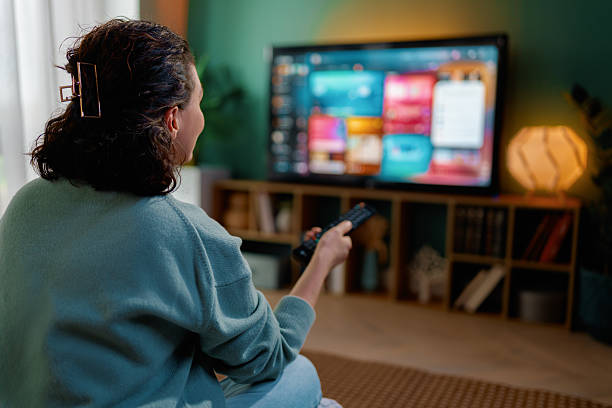 istock woman watching TV at home 2247243196