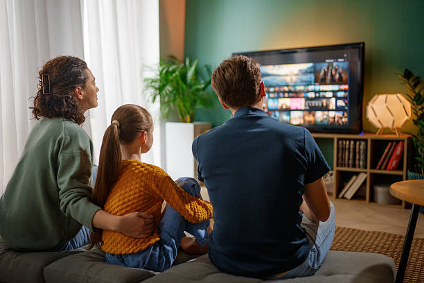 istock family watching  TV at home 2247243204