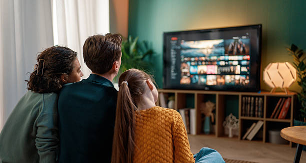 istock family watching  TV at home 2247243233