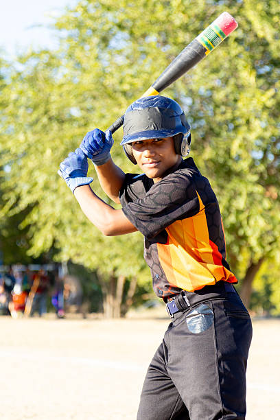 istock Young boy playing baseball bat swing outdoor 2247243814