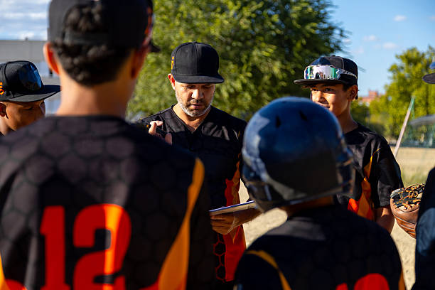 istock Baseball coach planning strategy with youth team 2247243815