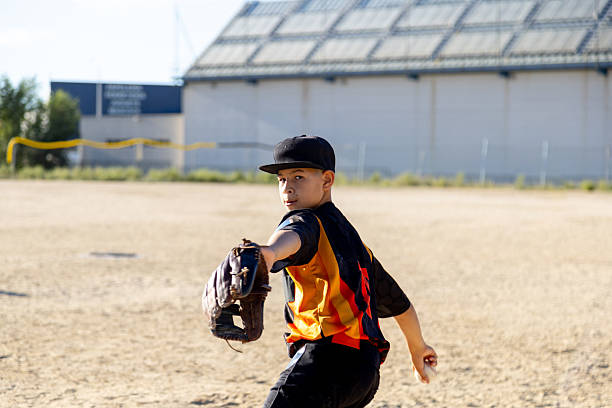 istock Youth baseball player pitching ball during game 2247243831