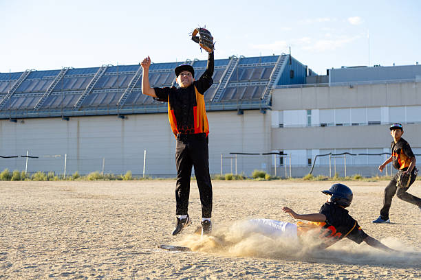 istock Young baseball players completing intense sports action 2247243857