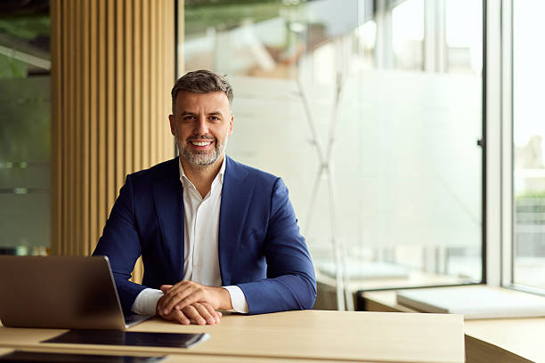 istock Professional Businessman At Modern Open-Plan Office Desk With Laptop 2247245470