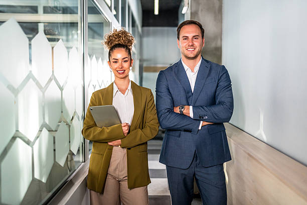 istock Business colleagues standing in modern corporate office 2247248568