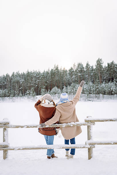 istock Two young women pose outdoors in a snowy forest. 2247249966