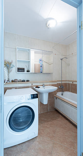 istock Modern Home Bathroom Interior with Bathtub and Washing Machine 2247251469
