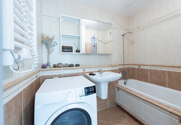 istock Modern Home Bathroom Interior with Bathtub and Washing Machine 2247251579