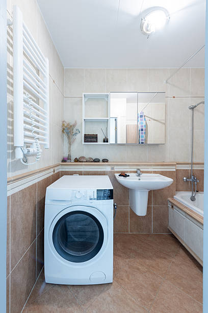 istock Modern Home Bathroom Interior with Bathtub and Washing Machine 2247251610