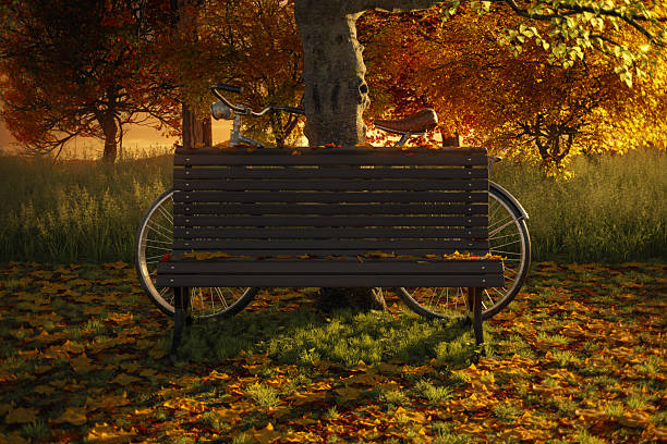 3D rendering of a park bench with a leaned bicycle covered in colorful autumn leaves
