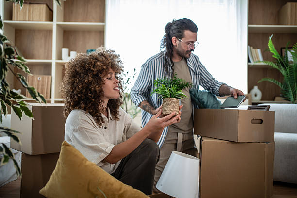 istock Couple unpacking boxes in new house, moving home 2247253213