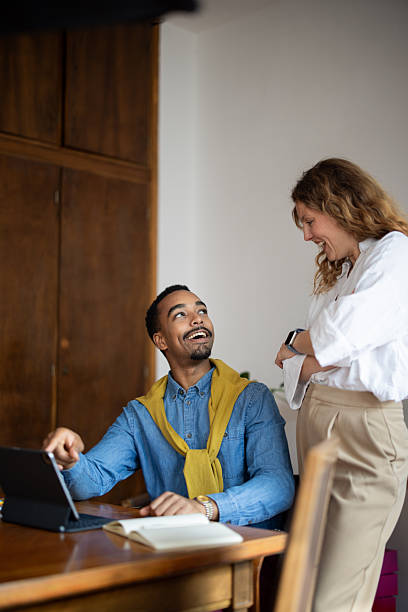 istock Diverse colleagues collaborating happily on digital tablet in office 2247253232