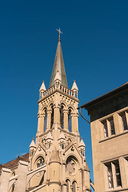 istock Church bell tower spire reaching clear blue sky 2247254356