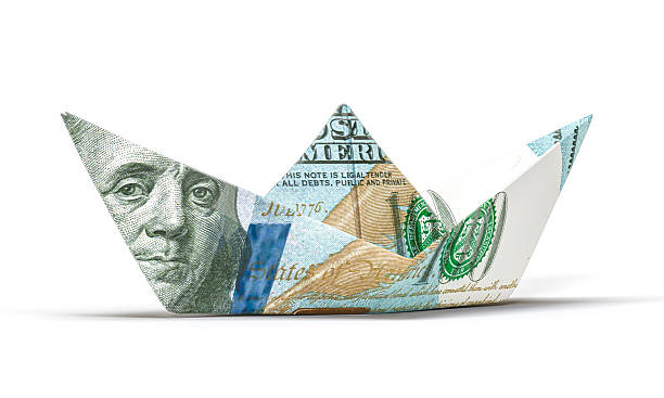 istock Hundred dollar paper boat symbolizing financial risk and investment 2247254366