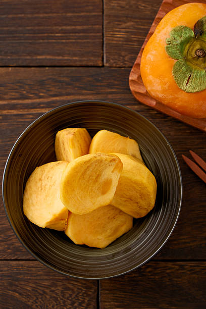 Sliced Persimmon Fruit Ready to Eat on Wooden Table