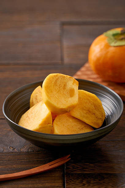 Sliced Persimmon Fruit Ready to Eat on Wooden Table